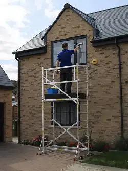 Cleaning second-story windows with a LOYAL scaffold tower